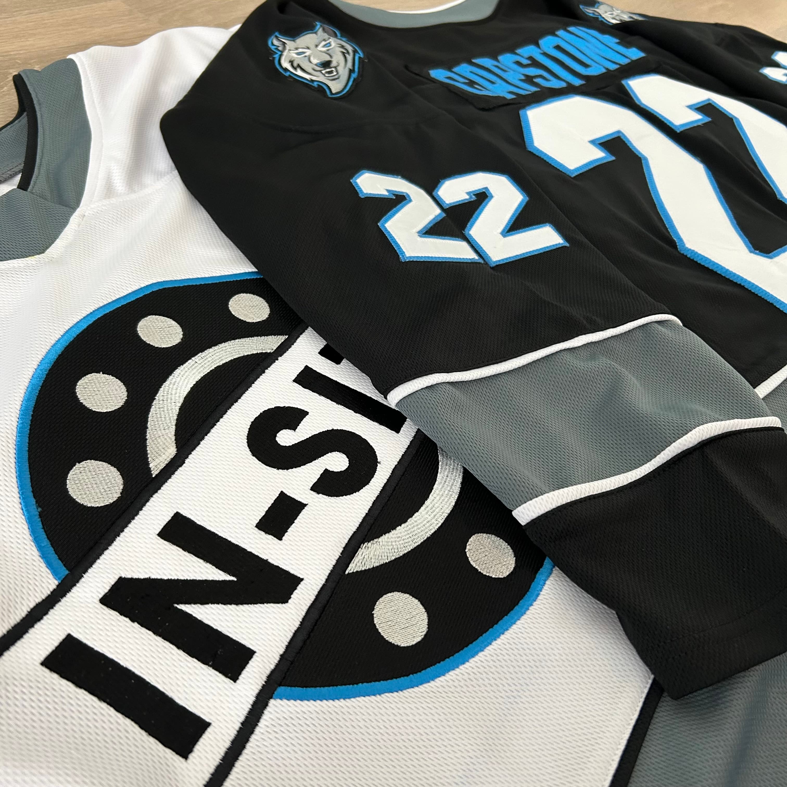 Custom hockey jerseys close-up — embroidered crests and numbering