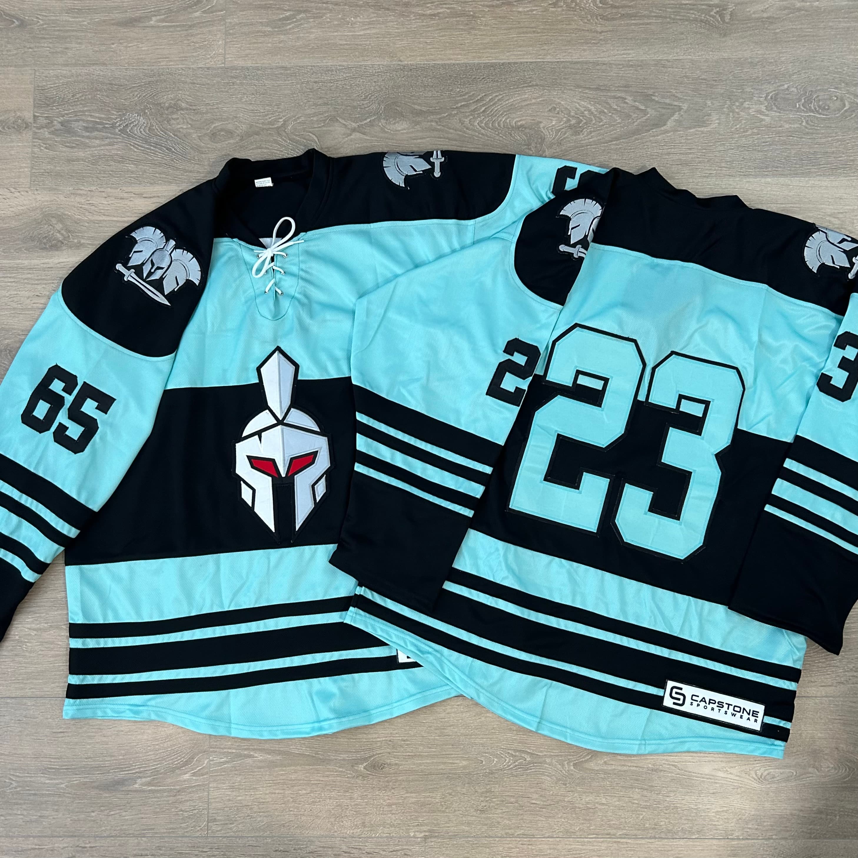 Spartan hockey jerseys — teal and black custom design
